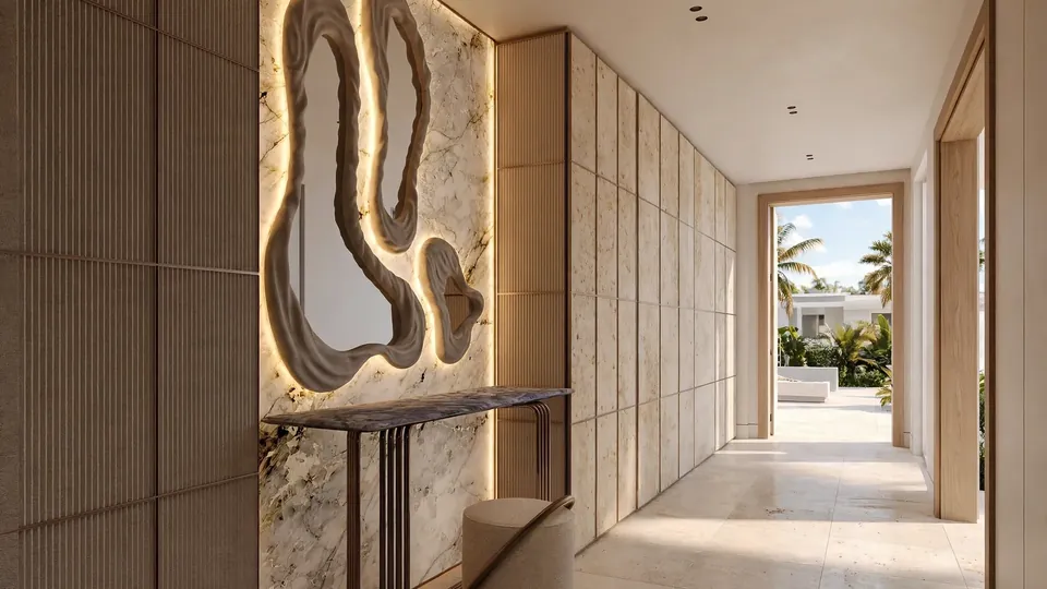 Entryway with a marble-look panel wall, backlit mirrors, a slim console and a travertine-look panel hallway opening to daylight